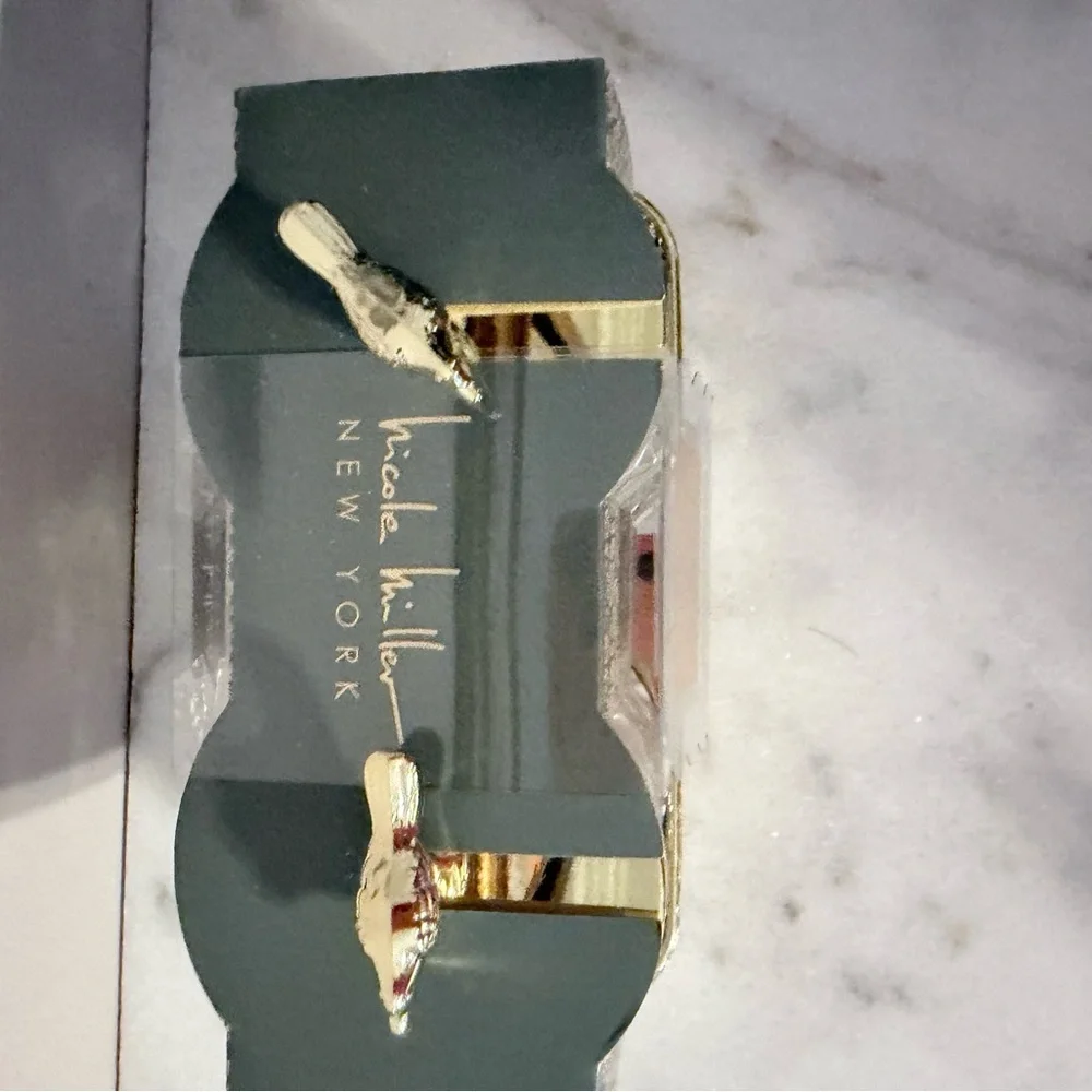 two-piece glass storage jar set with a gold bird lid and decorative tray.